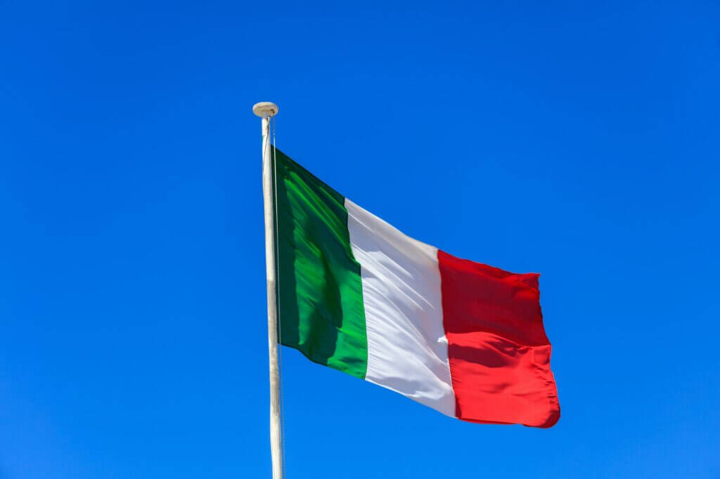 Italy flag. Italian flag on a pole waving on blue sky background